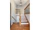 Inviting foyer with hardwood floors, wooden staircase, and classic chandelier at 326 Bethel Dr, Woodstock, GA 30189