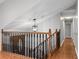 Foyer with wood railing and stairs, with hardwood floors and decorative light fixture at 326 Bethel Dr, Woodstock, GA 30189