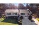 Well-maintained home with green lawn and mature landscaping in front at 326 Bethel Dr, Woodstock, GA 30189