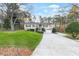 Inviting home featuring a lush front lawn, mature landscaping, and a paved driveway at 326 Bethel Dr, Woodstock, GA 30189