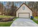Detached garage with gable roof, concrete driveway, and landscaped lawn at 326 Bethel Dr, Woodstock, GA 30189