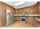 Kitchen with stainless steel appliances, tile backsplash, wooden cabinets, and granite countertops at 326 Bethel Dr, Woodstock, GA 30189