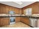 Kitchen with wooden cabinets, granite countertops, tile backsplash, and stainless steel appliances at 326 Bethel Dr, Woodstock, GA 30189