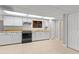 Basement kitchenette with white cabinets, wood countertops, and a black gas range at 326 Bethel Dr, Woodstock, GA 30189