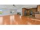 Open living space with hardwood floors next to a kitchen with stainless steel appliances at 326 Bethel Dr, Woodstock, GA 30189