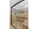 Tiled shower with glass doors, mosaic accents and built in bench at 326 Bethel Dr, Woodstock, GA 30189