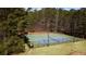 Aerial shot of the community tennis and multi-use sport courts surrounded by trees at 326 Bethel Dr, Woodstock, GA 30189