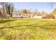 Expansive backyard showing the house, a storage shed, and ample green space, perfect for recreation at 8684 Chestnut Ln, Lithia Springs, GA 30122