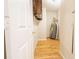 Utility room with water heater, wood flooring, and storage at 8684 Chestnut Ln, Lithia Springs, GA 30122