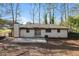 View of the backyard featuring a patio and lush green grass with mature trees at 2379 Ridgeway Dr, Atlanta, GA 30360