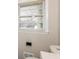 Bathroom featuring a window and toilet at 2379 Ridgeway Dr, Atlanta, GA 30360