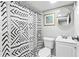 Cozy bathroom with graphic shower curtain, vanity, toilet and round mirror at 239 Lindbergh Ne Dr, Atlanta, GA 30305