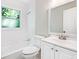 Bright bathroom featuring a tub with white tiled walls, white sink and vanity, and window at 239 Lindbergh Ne Dr, Atlanta, GA 30305