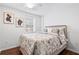 Bedroom with a queen-size bed, hardwood floors, natural light, and modern wall art at 239 Lindbergh Ne Dr, Atlanta, GA 30305