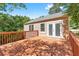 Spacious stained deck, accessible from the interior, surrounded by lush trees at 239 Lindbergh Ne Dr, Atlanta, GA 30305