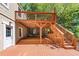 Two-tiered stained deck with stairs and a door leading to interior space at 239 Lindbergh Ne Dr, Atlanta, GA 30305