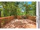 Spacious stained deck surrounded by lush trees, perfect for outdoor enjoyment at 239 Lindbergh Ne Dr, Atlanta, GA 30305