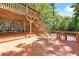 Two-tiered stained deck, surrounded by lush trees, featuring multiple staircases at 239 Lindbergh Ne Dr, Atlanta, GA 30305