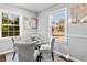 Formal dining area with a glass table, upholstered chairs, and natural light at 239 Lindbergh Ne Dr, Atlanta, GA 30305