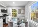 Breakfast nook with a modern glass table, upholstered chairs, and bright windows at 239 Lindbergh Ne Dr, Atlanta, GA 30305