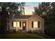 Charming exterior view of a home with a covered porch, swing, and attractive landscaping at dusk at 239 Lindbergh Ne Dr, Atlanta, GA 30305