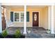 Inviting front porch with a classic swing, neutral tones, and stylish slate tile flooring at 239 Lindbergh Ne Dr, Atlanta, GA 30305