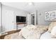 Spacious main bedroom with a television, ceiling fan, and bright, sunny windows at 239 Lindbergh Ne Dr, Atlanta, GA 30305