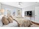 Cozy main bedroom with a decorative bed, ceiling fan, and deck access at 239 Lindbergh Ne Dr, Atlanta, GA 30305