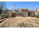 Brick home featuring a backyard and stone patio with table and chairs, perfect for relaxing at 407 Spring House Ne Cv, Atlanta, GA 30307