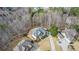 Aerial view features a two-story home with a driveway, yard, and landscaping at 6350 Old Wood Hollow Way, Buford, GA 30518