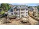 Back exterior of home, featuring a multi-level deck and large windows with private yard at 6350 Old Wood Hollow Way, Buford, GA 30518