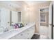 Bright bathroom featuring double sinks, spacious vanity, and a well-lit mirror at 6350 Old Wood Hollow Way, Buford, GA 30518