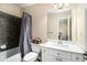 Well-lit bathroom with a shower-tub, vanity, and neutral color scheme at 6350 Old Wood Hollow Way, Buford, GA 30518