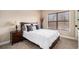 Cozy bedroom with a comfortable bed, neutral tones, and a window offering natural light at 6350 Old Wood Hollow Way, Buford, GA 30518