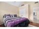 Cozy bedroom featuring a comfortable bed, closet, and hardwood floors, adjacent to hallway at 6350 Old Wood Hollow Way, Buford, GA 30518