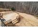 Backyard deck with a wooded backdrop and stairs leading to the yard at 6350 Old Wood Hollow Way, Buford, GA 30518