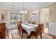 Dining room with hardwood floors, decorative rug, wainscoting, and large window at 6350 Old Wood Hollow Way, Buford, GA 30518