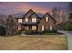 Beautiful two-story brick home with manicured landscaping and a welcoming covered front porch at 6350 Old Wood Hollow Way, Buford, GA 30518