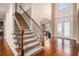 Elegant foyer featuring hardwood floors, a staircase, and double doors with decorative glass at 6350 Old Wood Hollow Way, Buford, GA 30518
