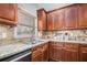 Well-appointed kitchen featuring granite countertops, stainless appliances, and custom cabinetry at 6350 Old Wood Hollow Way, Buford, GA 30518