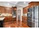 Modern kitchen with stainless steel appliances, dark wood cabinets, and a center island at 6350 Old Wood Hollow Way, Buford, GA 30518