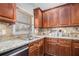 Well-appointed kitchen featuring granite counters, stainless appliances and subway tile backsplash at 6350 Old Wood Hollow Way, Buford, GA 30518