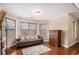 Cozy living room featuring hardwood floors, large windows, and a comfortable couch at 6350 Old Wood Hollow Way, Buford, GA 30518