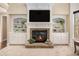 Cozy fireplace with built-in shelving creates a warm and inviting atmosphere in the living room at 6350 Old Wood Hollow Way, Buford, GA 30518