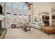 Inviting living room with fireplace, soaring windows, and open layout offering plenty of space to relax at 6350 Old Wood Hollow Way, Buford, GA 30518