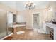 Bathroom featuring a glass-enclosed shower, soaking tub, and double vanity with a chandelier at 6350 Old Wood Hollow Way, Buford, GA 30518