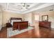 Expansive main bedroom offers ample space, hardwood floors, and a glimpse into the luxurious ensuite bathroom at 6350 Old Wood Hollow Way, Buford, GA 30518