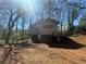 View of two-story home's rear exterior with fenced yard and exterior access at 80 Harlan Sw Rd, Atlanta, GA 30311