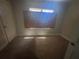 Modest bedroom with carpeted floor, small window and an adjacent closet or doorway at 80 Harlan Sw Rd, Atlanta, GA 30311