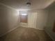 Neutral bedroom with tan carpeting and a single window for natural light at 80 Harlan Sw Rd, Atlanta, GA 30311